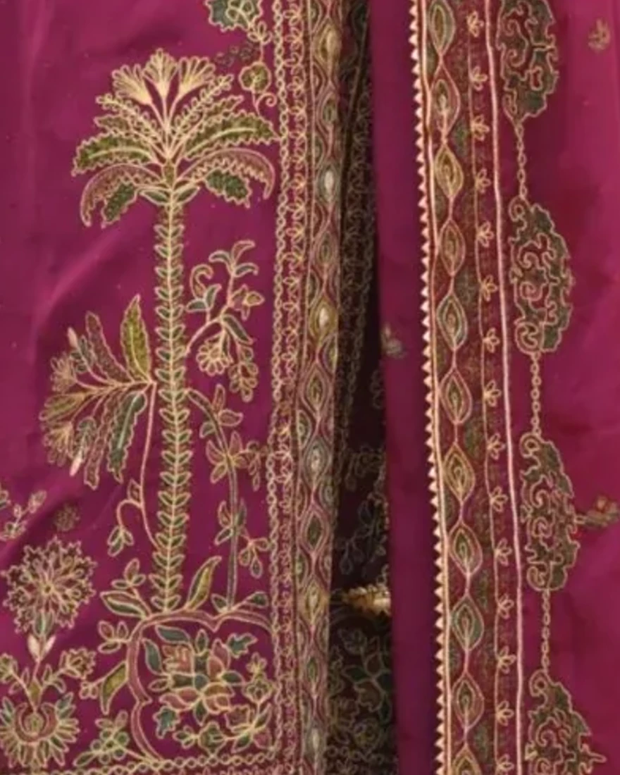 A couture textile panel of heritage motifs with fine borders and central detailing.